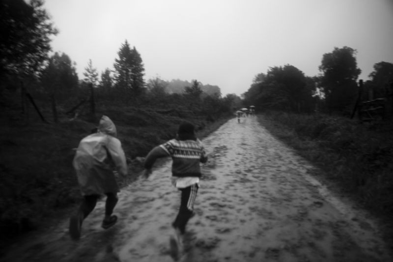 © Mercedes Cotoli - Kids going running home on a rainy day.