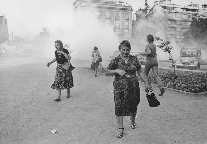 © Julio Etchart - Women suffer from tear gas during a demonstration against Pinochet on International Women's Day. Santiago; Chile, 1985