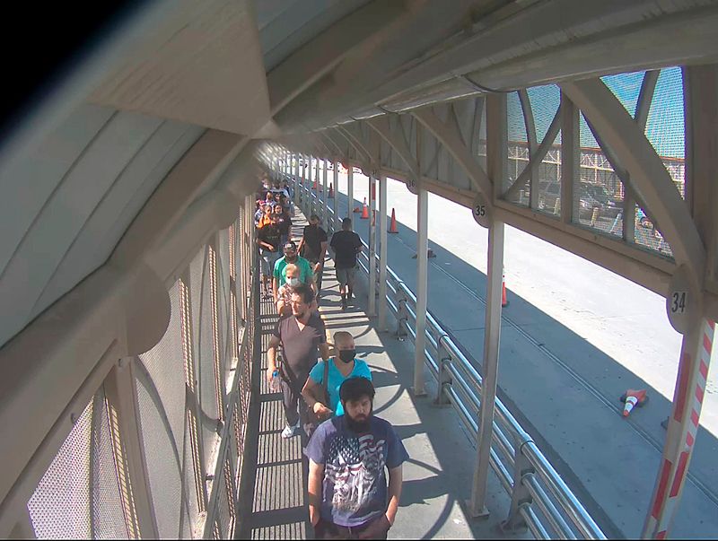 © Alejandro "Luperca" Morales - Self-Portrait Wearing Second-Hand U.S. Flag and Wolves T-Shirt While Crossing to El Paso