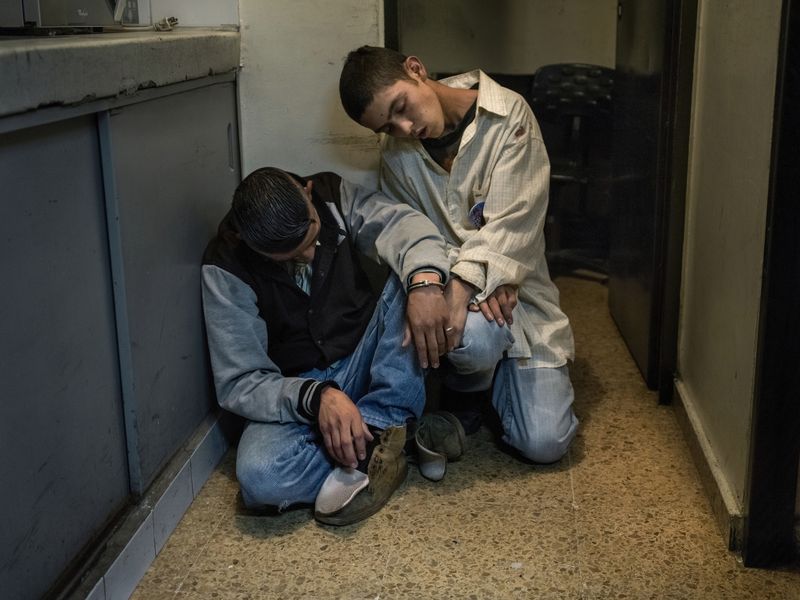 © Mads Nissen - Two young boys on drugs -completely out of reach- are being arrested by the police after some street fighting.
