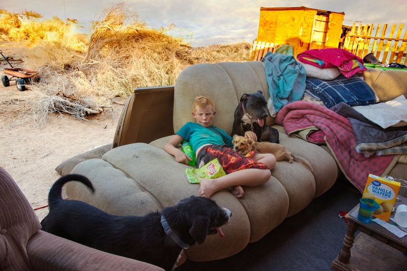 © Barbara Peacock - Timothy - Age 9'On hot nights I sleep outside with the dogs.'Slab City, California