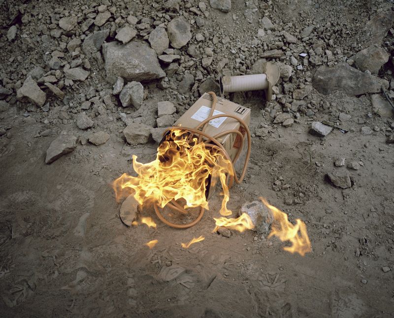 © Filippo Menichetti Martin Errichiello - Leftovers of a detonating cord are burned after a controlled demolition.