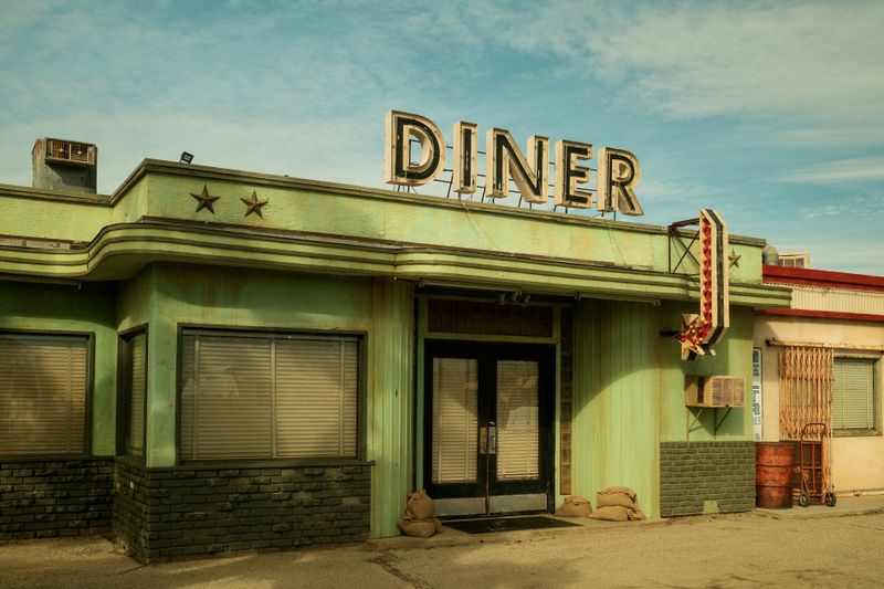 © Gem Redford - Mojave Desert, CaliforniaAbandoned diner exterior in desert landscape.