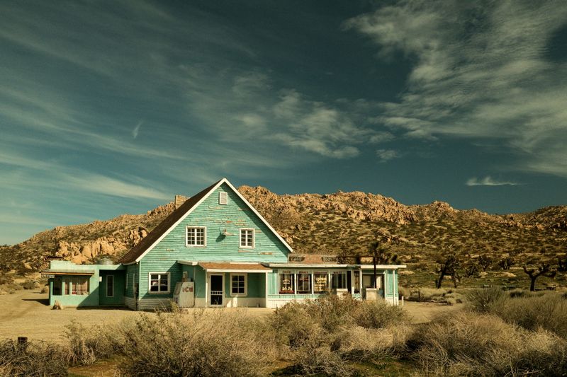 © Gem Redford - Mojave Desert, CaliforniaIsolated diner building surrounded by desert terrain.