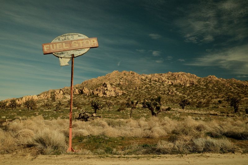 © Gem Redford - Mojave Desert, CaliforniaIsolated roadside sign in desert landscape.