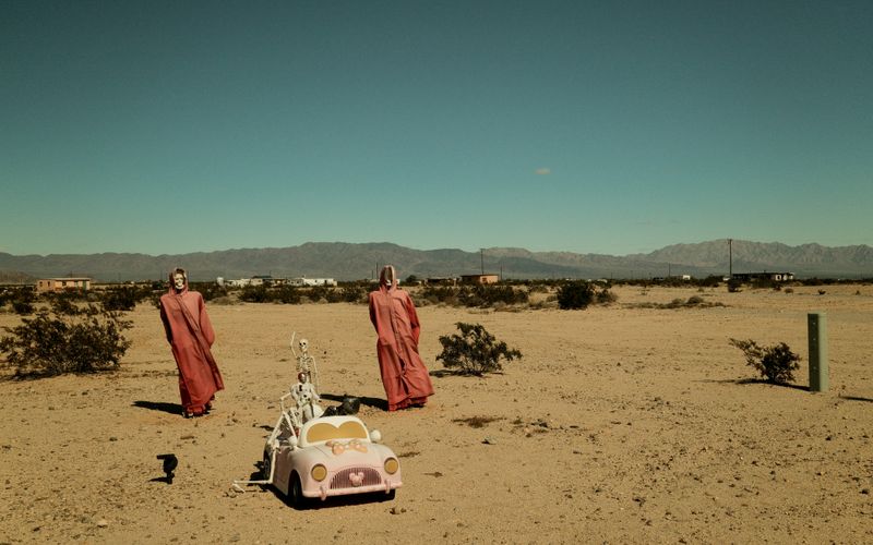 © Gem Redford - Mojave Desert, CaliforniaInstallation skeleton figures in open desert landscape.
