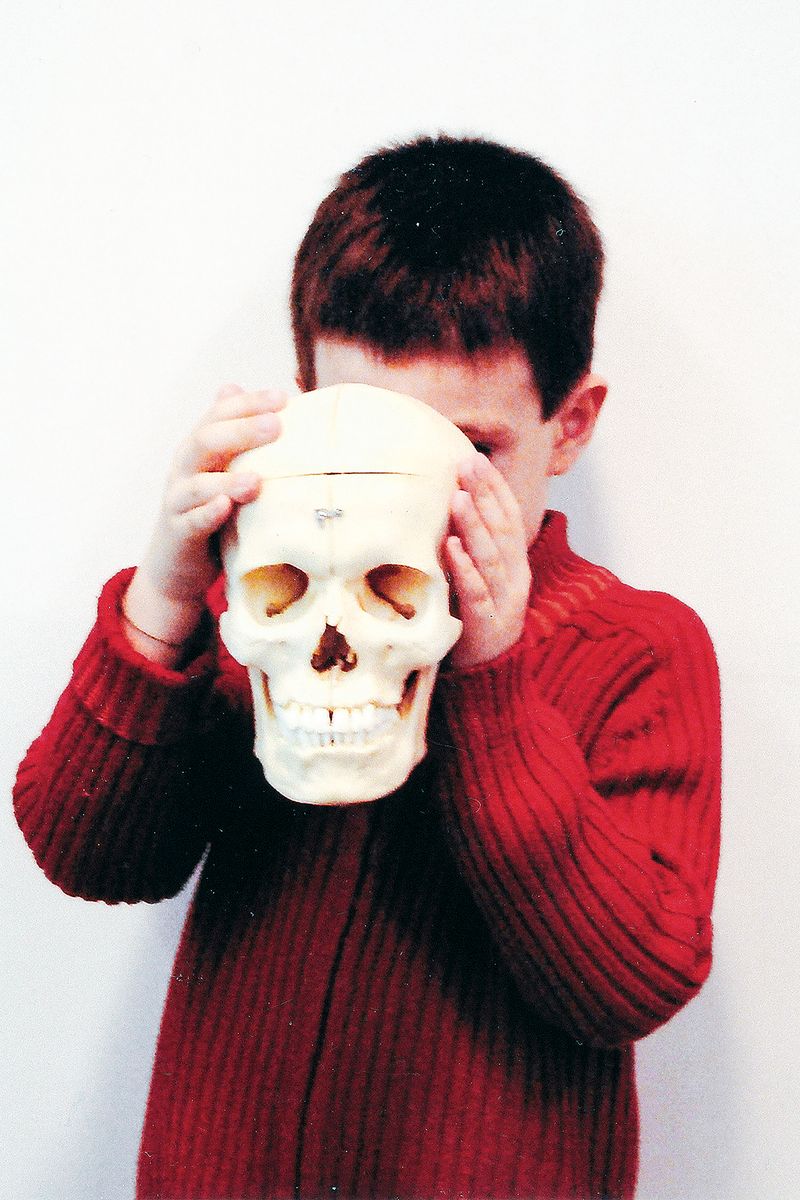 © Anna Galí - Old film photo showing my son Tomeu with a plastic skull, from the family photo album