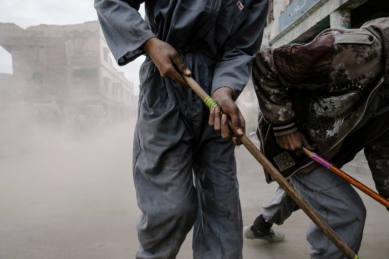 © Alexandra Howland - Hired workers sweep the road outside Al Nuri Mosque following the liberation of Mosul from ISIS. January 9, 2018