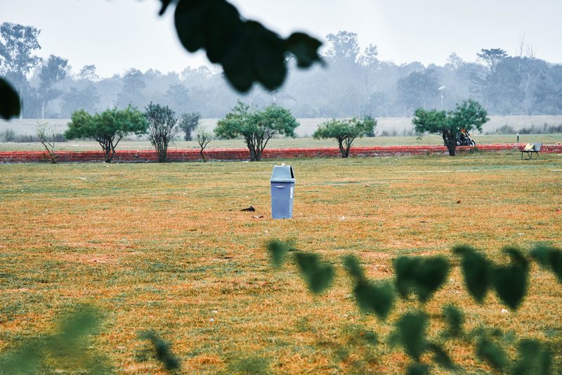© tibhesh - An old dustbin is in the middle of the ground outside the Sacred Garden.