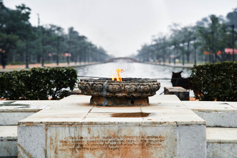 © tibhesh - Eternal Peace Flame with Stray Dog overlooking the waterway.