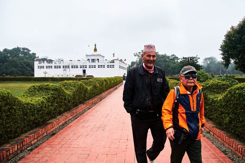 © tibhesh - Tourists are happy after visiting the Mayadevi Temple.