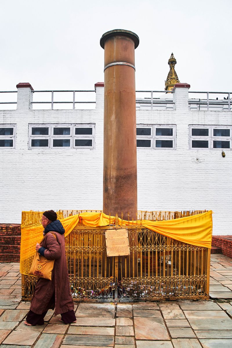 © tibhesh - A Buddhist Pilgrim circling around the Ashoka Piller as a tradition of worship.