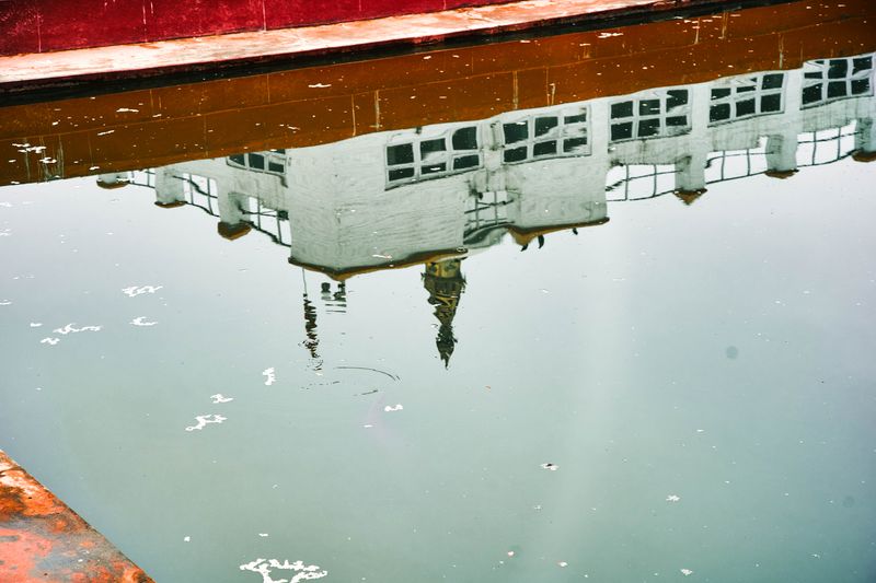 © tibhesh - Reflection of Mayadevi Temple on the unclean and contaminated pond.