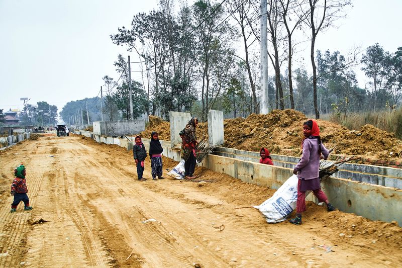 © tibhesh - Local Children collecting small firewoods in sacks for cooking later at home with their guardian in West Monastery Street.