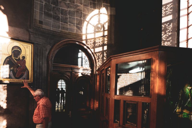 © Stefanos Chronis - Man is praying at Orthodox Church of Three Holy Hierarchs Monastery at the city Iasi Romania. Religion Christian Orthodox