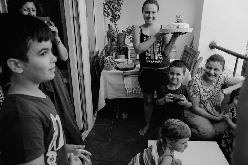 © Mariya Sabotinova - Irena bringing a cake at a birthday party
