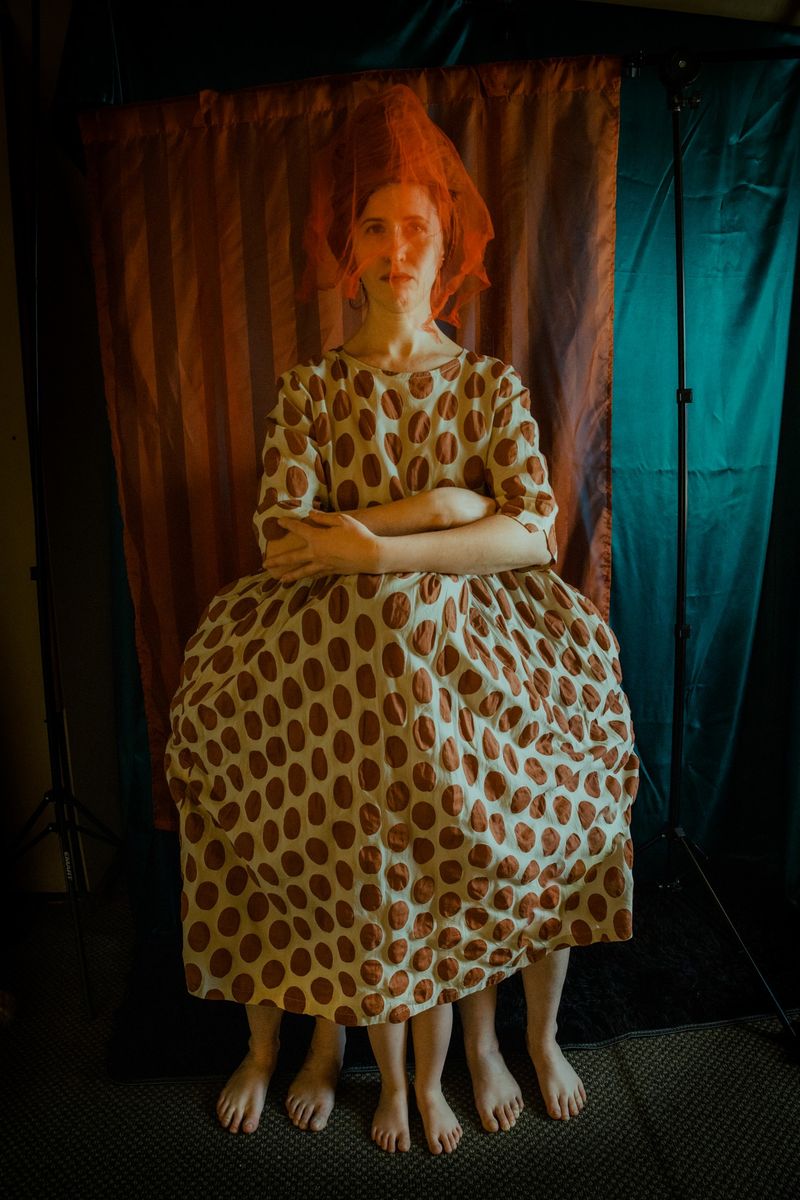 © Mari Saxon - I am the only one who lives here (A mother hides her daughters beneath her wide skirt, shielding them from unfriendly eyes.)