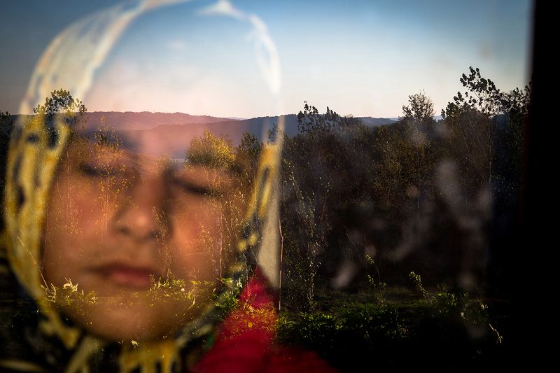 © Zohreh Saberi - Raheleh, 13, born blind, standing behind the window in the morning. She likes the warmness of the sunlight on her face.