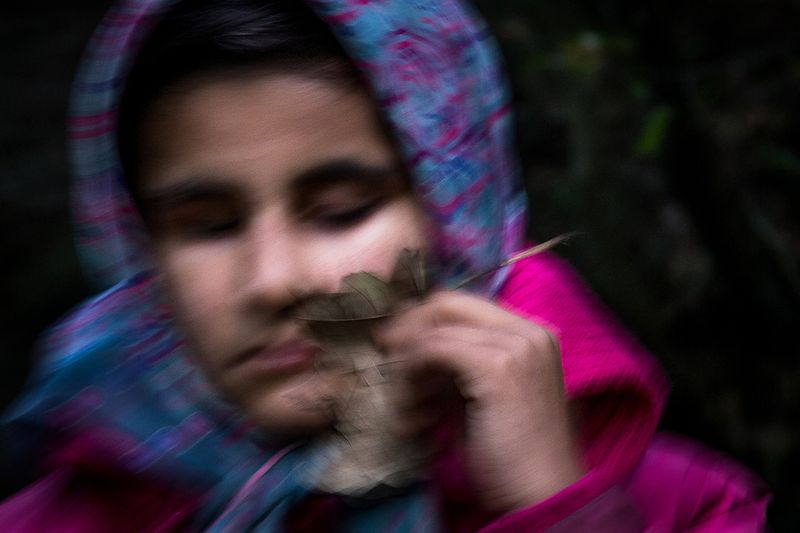 © Zohreh Saberi - Raheleh, 13, born blind, walking in a forest near her house. She feels the leaves by touching them with her face.