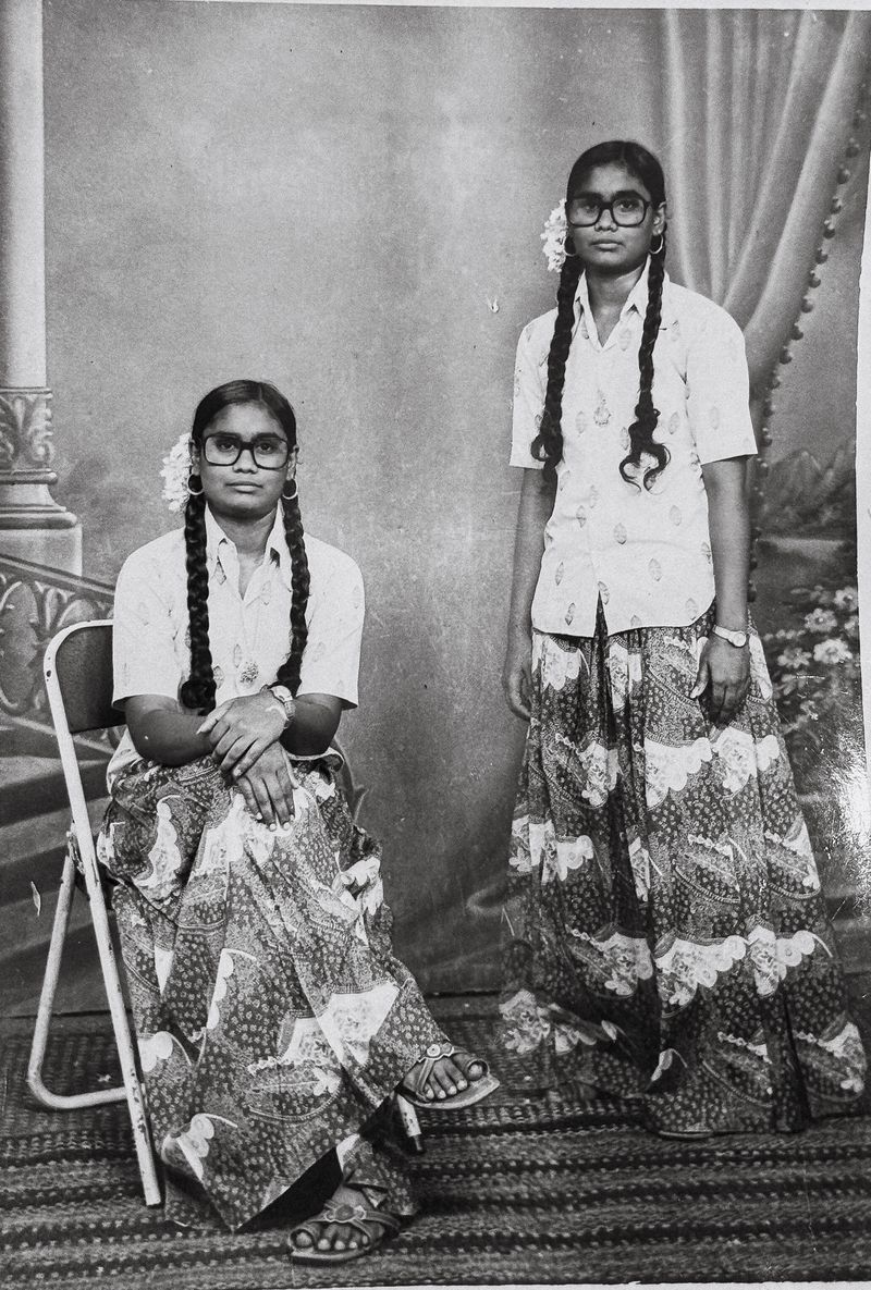 © Deepthi - Family archive. Double-exposure studio portrait of my aunt, appearing twice within the same frame, Tamil Nadu, [1983].