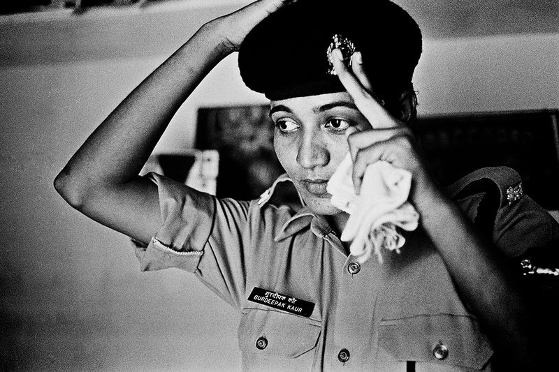 © Poulomi Basu - Kaur Walia, putting on her uniform at home before leaving for the border. Kharkan Chowk Village, Punjab September 2009.