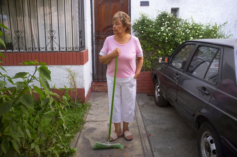 © Rochi  Leon - My mom watches the street while sweeping.