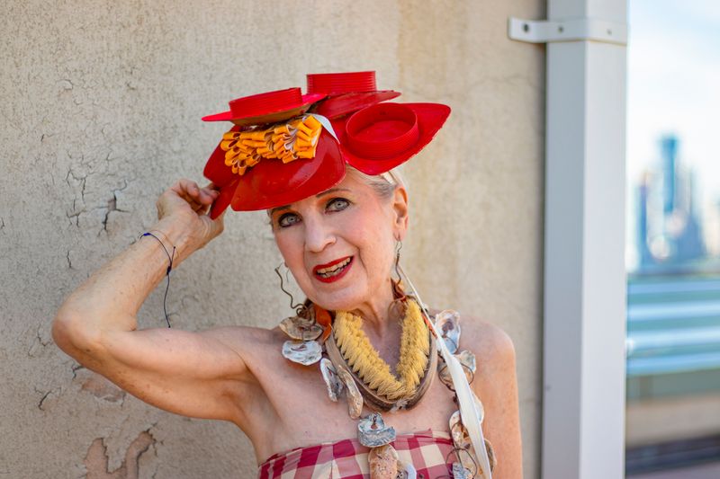© Natalia L Rudychev - Debra Rapoport modeling her hat made from 5 palm leaf plates with cloth and plastic embellishments.