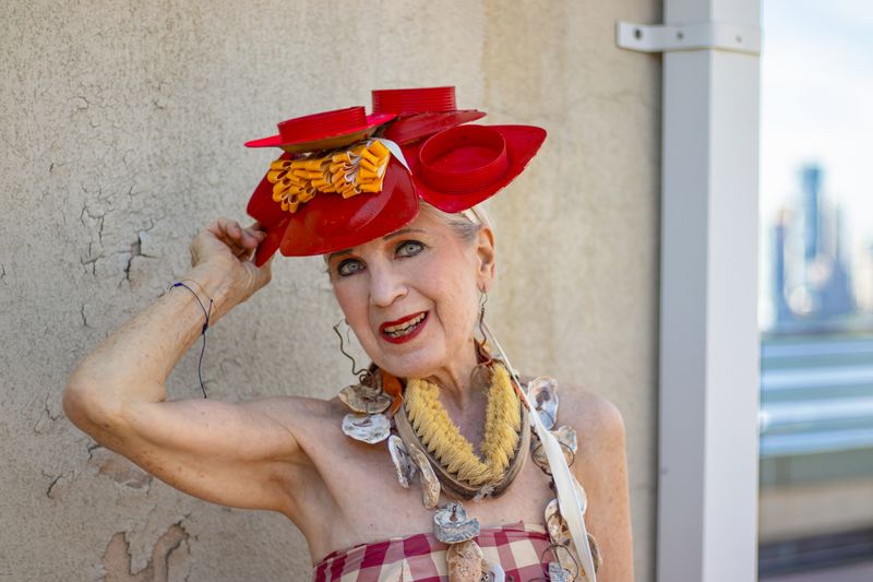 © Natalia L Rudychev - Debra Rapoport modeling her hat made from 5 palm leaf plates with cloth and plastic embellishments.