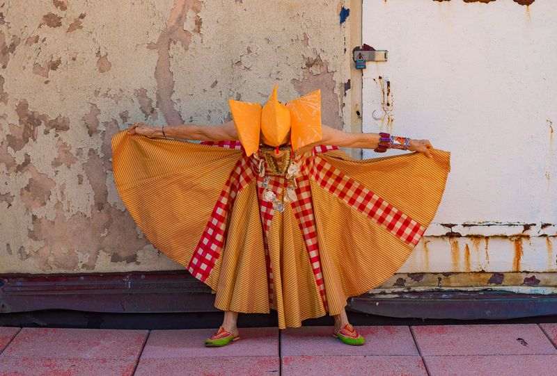 © Natalia L Rudychev - Debra Rapoport modeling vintage garment, toilet paper roll bracelet and airplane giftbag hat.