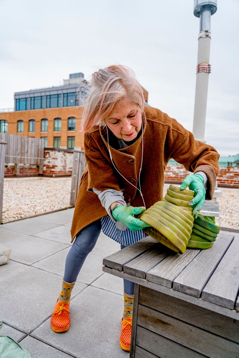 © Natalia L Rudychev - Debra Rapoport at work creating her famous paper towel hats.