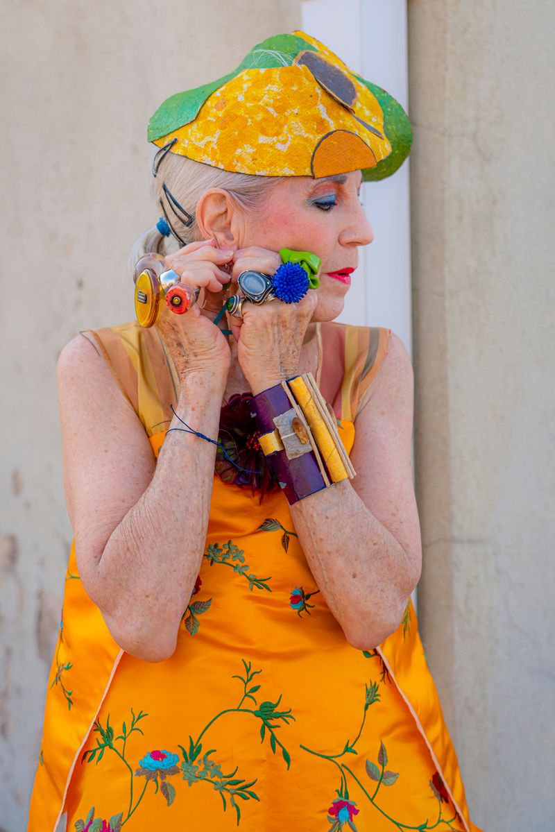 © Natalia L Rudychev - Vulnerable moment. Debra Rapoport wearing her toilet paper bracelets and recycled materials hat.