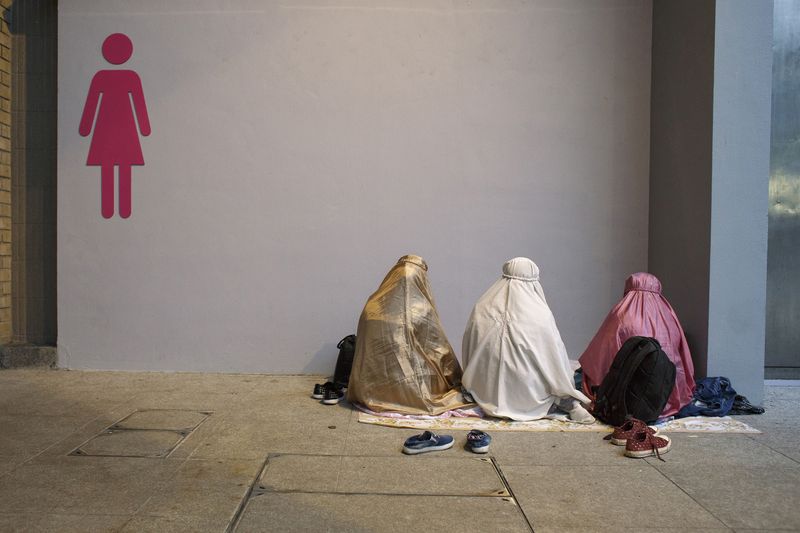 © Rebecca Sampson - This way to Mecca - praying outside public toilet, public park, Hong Kong