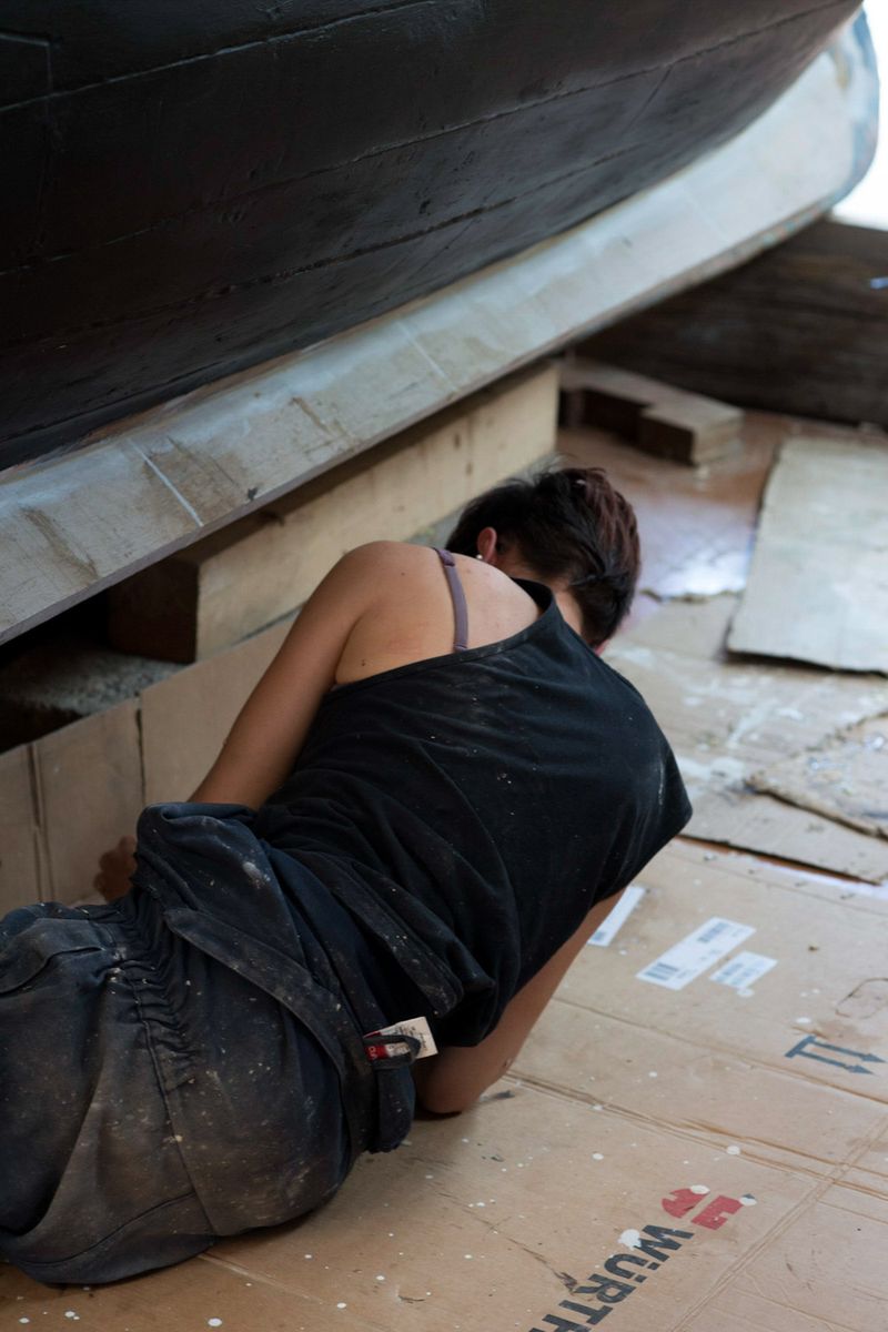 © Julie Bourges - Cecile is working on an old catalan boat in the boat workshop, Paulilles, South of France