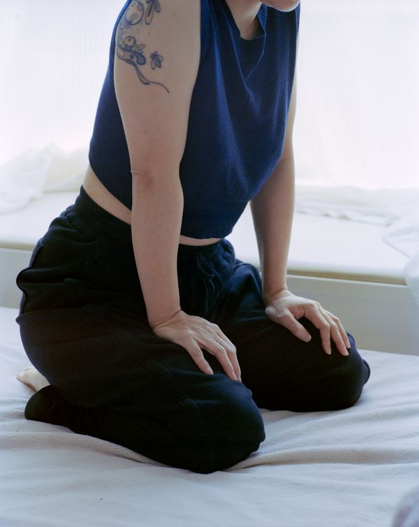 © Tianxi Wang - Girl with a Bee Tattoo, Kneeling on the Bed