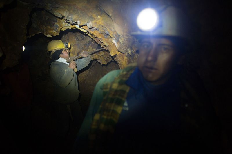 © Toby Binder - Brayan (15) is working inside the mine together with his brother Luis (17) and their cousin Eduardo (29).