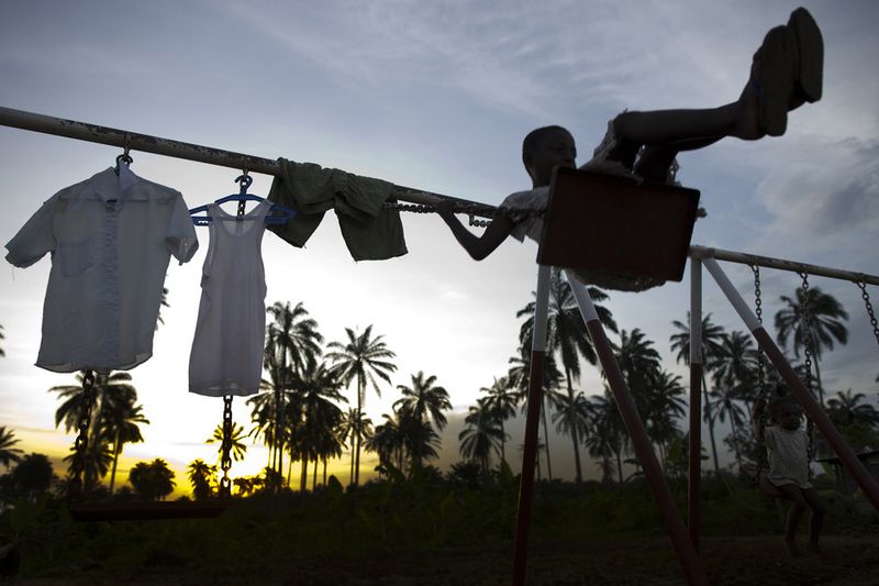 © Toby Binder - Emediong is swinging on the playground of the CRARN-Centre.
