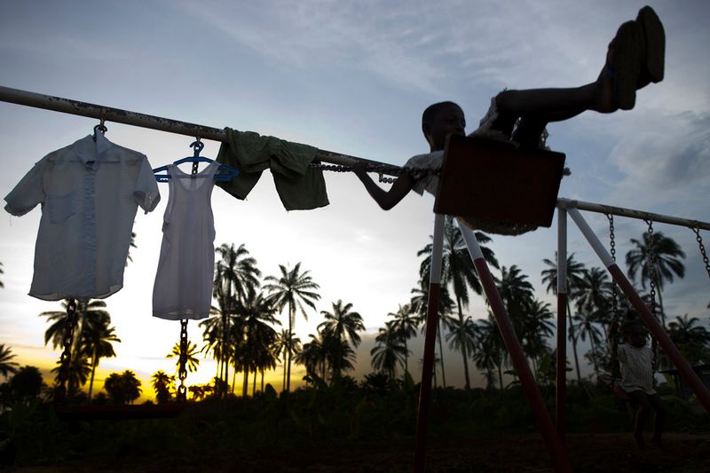 © Toby Binder - Emediong is swinging on the playground of the CRARN-Centre.