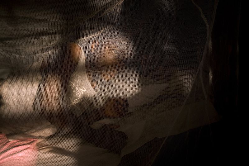 © Toby Binder - Helen in one of the dormitories. Often two children have to share one bed because daily newcomers arrive.