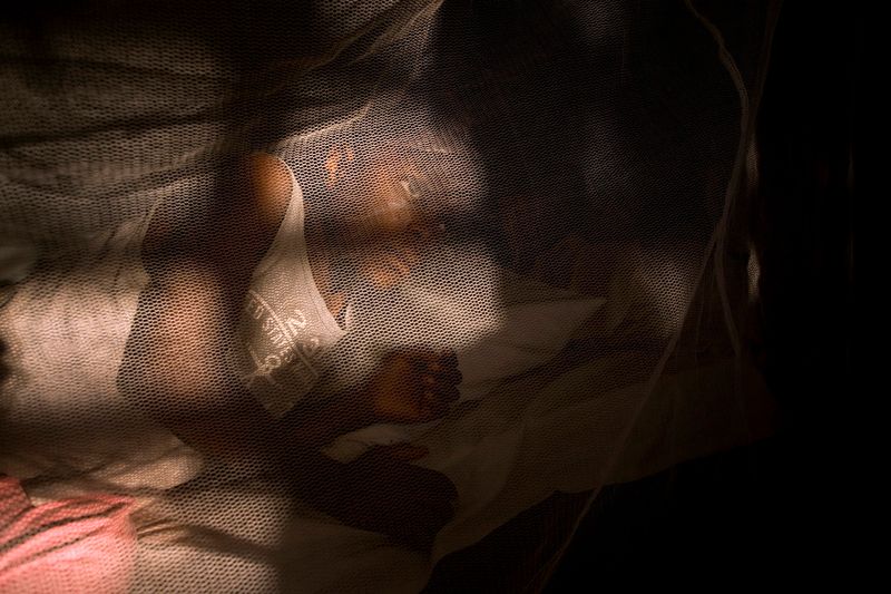 © Toby Binder - Helen in one of the dormitories. Often two children have to share one bed because daily newcomers arrive.