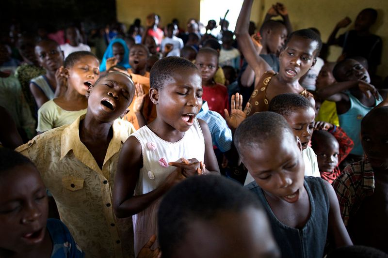 © Toby Binder - Children are singing during the Sunday service at the Centre of CRARN.
