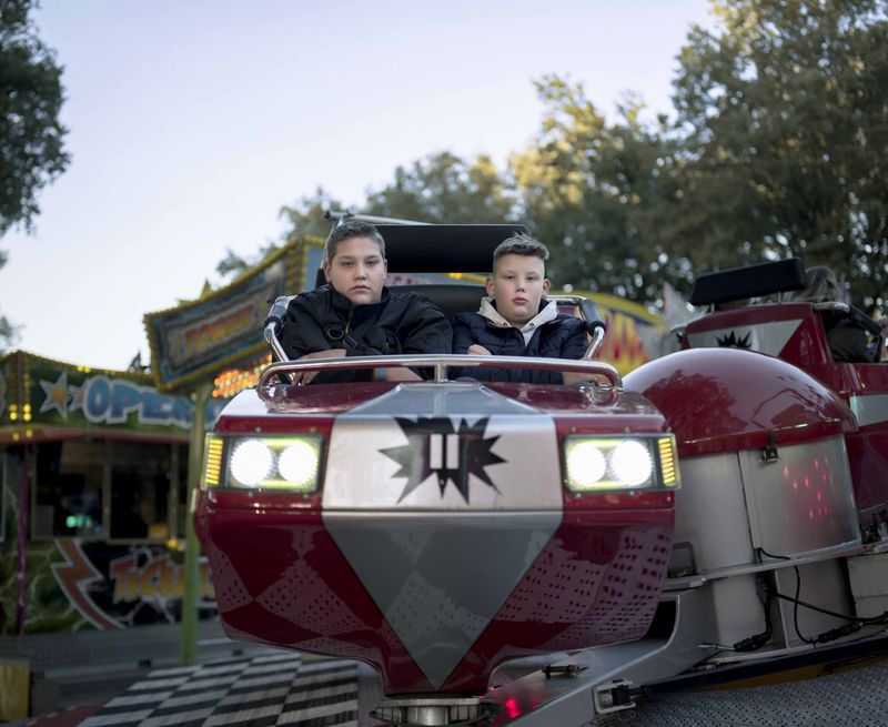 © Nina Schollaardt - Strangers (16) and (11) at the fun fair in Zuid-Laren, October 2023