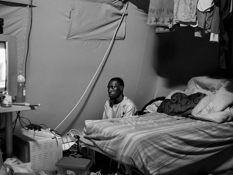 © Marco Zanella - Italy. 2019. San Ferdinando, Calabria. Official tent city for migrants. A seasonal migrant worker prayn' in his tent.