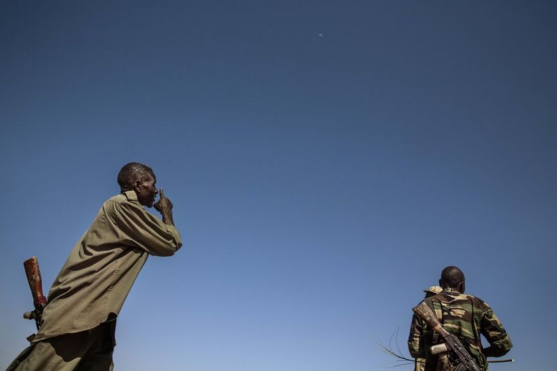 © Marco Gualazzini - Africa, Sudan, South Kordofan. The passage of an Antonov above the front line causes tension among the troops. 2nd dec 2013