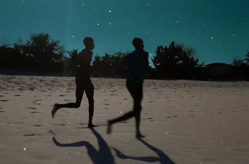 © yingying gao - August 2023, Dar es Salaam. Two people running on the beach.