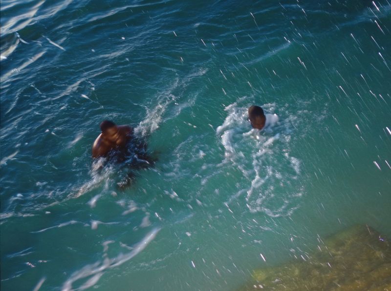 © yingying gao - August 2023, Dar es Salaam. Two people swimming in the ocean.