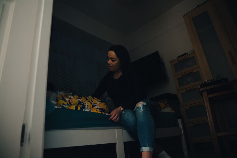 © Sarah Chandy - 06:10 She wakes her son and leaves. He eats alone and walks to the school bus.