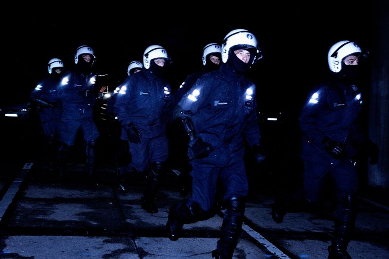 © Giovanni Troilo - Police officers charging the hooligans. In Charleroi the highest building is the police station which is 75m high.