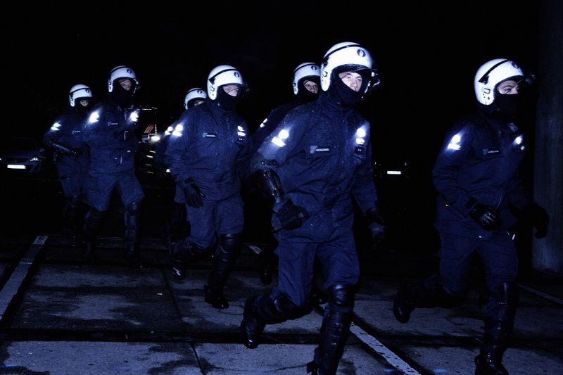 © Giovanni Troilo - Police officers charging the hooligans. In Charleroi the highest building is the police station which is 75m high.
