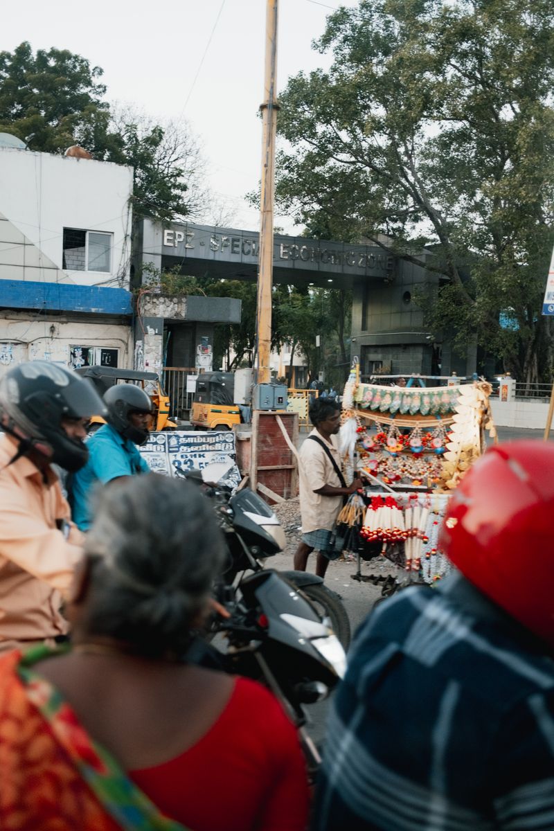 © Yvonne Chu - Garlands beside factory gates; ritual crosses into industry without changing its tempo.