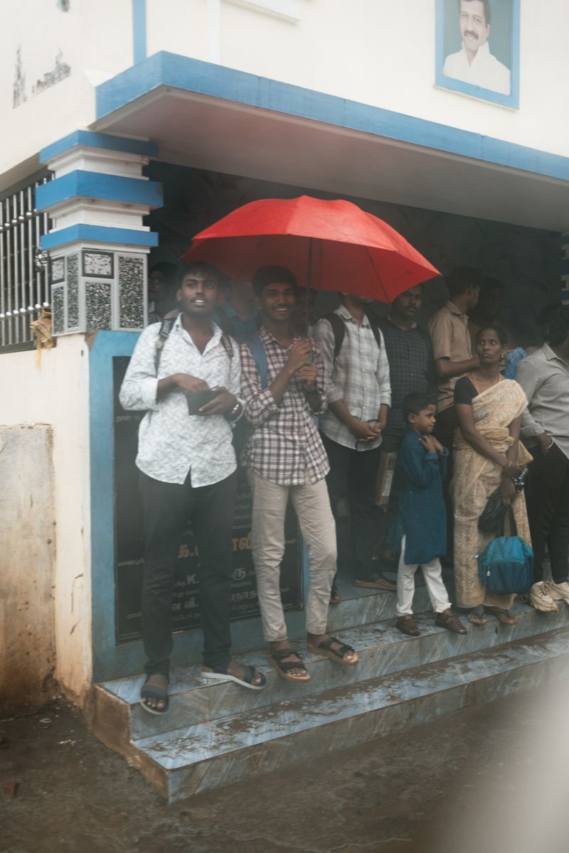 © Yvonne Chu - A red umbrella marks the doorway; a threshold between rain, routine, and shelter.